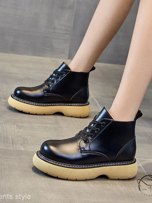 Stylish thick-sole leather ankle boots in black with yellow soles