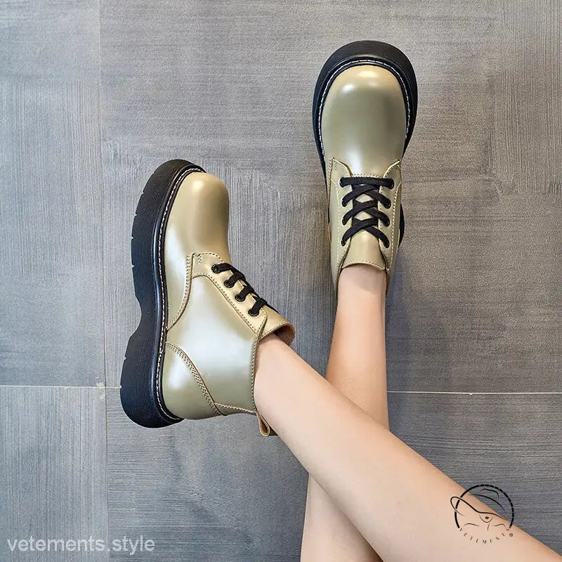 Stylish thick-sole leather ankle boots in metallic gold with black laces