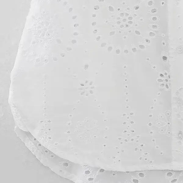 White eyelet fabric detail on summer embroidered shirt with pocket and short sleeves