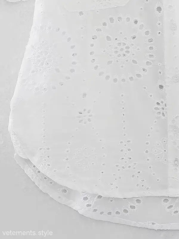 White eyelet fabric detail on summer embroidered shirt with pocket and short sleeves