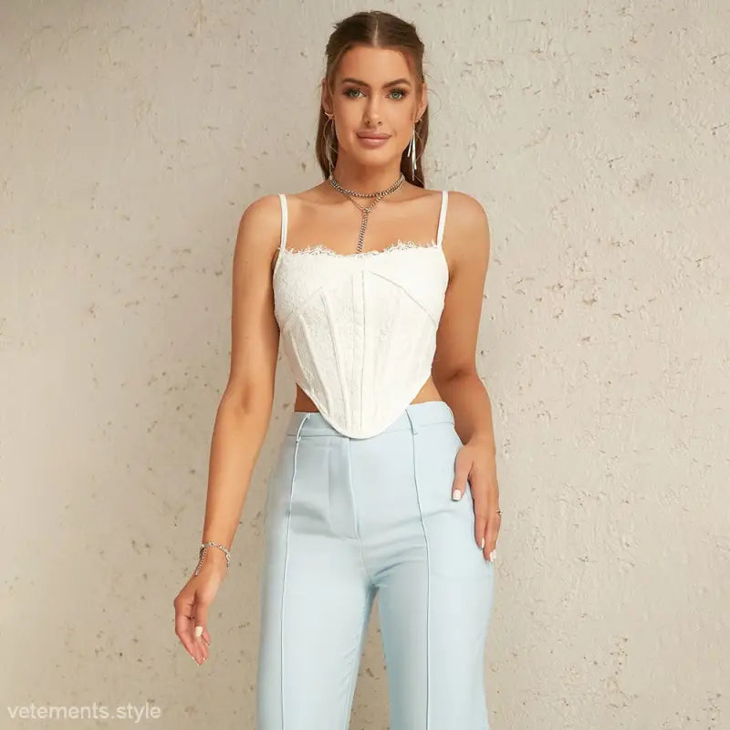 Woman in white boning corset and light blue high-waisted pants for summer sexy style