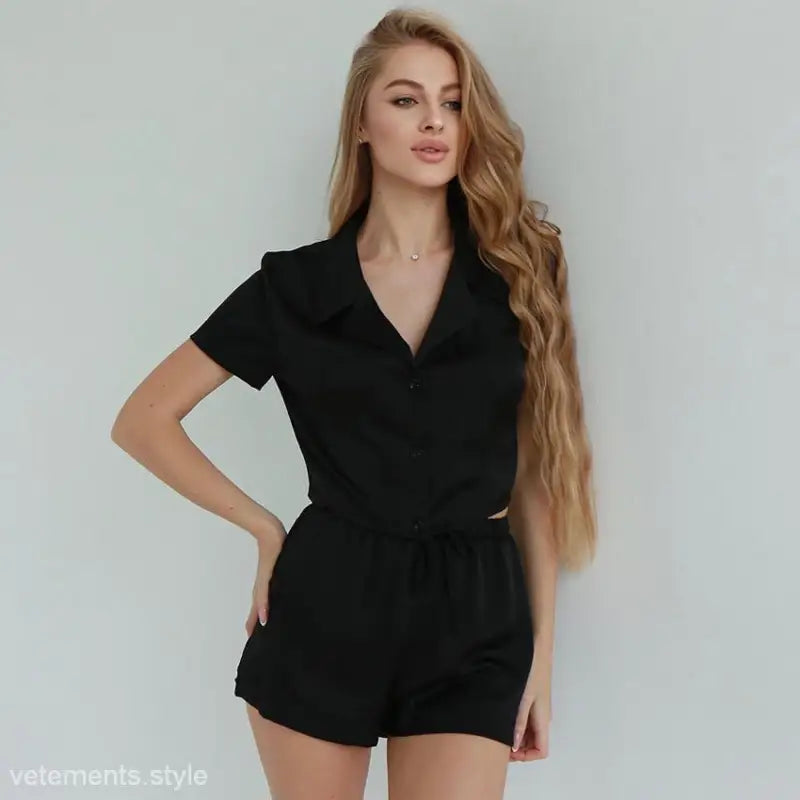 Woman in black summer sporty pajamas set with satin sleeve shorts for stylish comfort