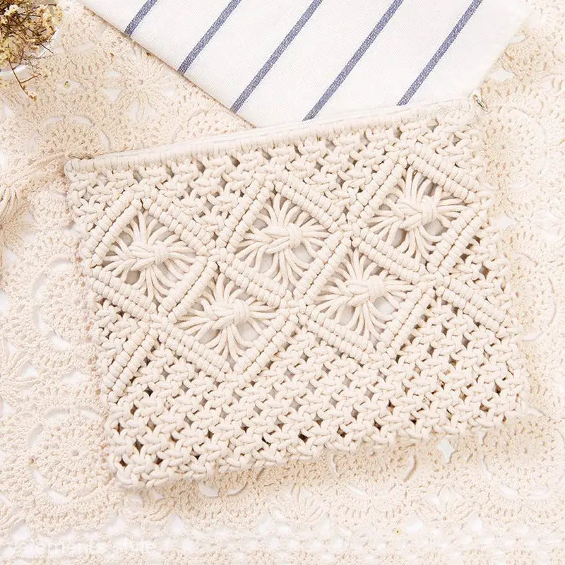 Cream-colored macramé clutch with geometric patterns for bohemian beach bag versatility