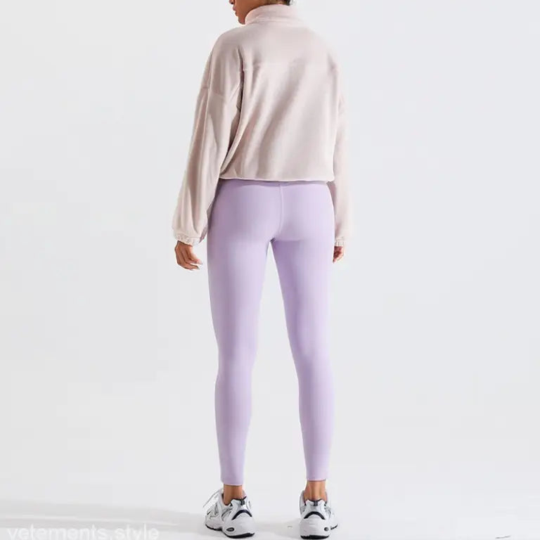 Woman in lavender leggings and beige sweatshirt wearing Temperament Pink fleece sports jacket