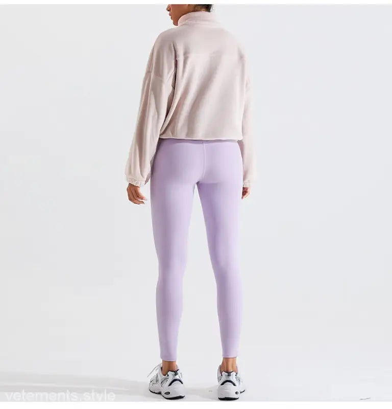 Woman in lavender leggings and beige sweatshirt wearing Temperament Pink fleece sports jacket