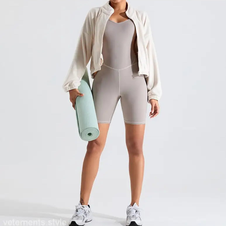 Woman in athletic wear holding yoga mat wearing Temperament Pink fleece sports jacket