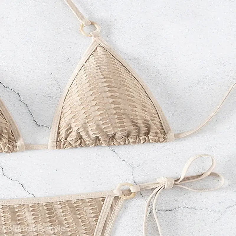 Beige textured bikini featuring sexy lacing, perfect for summer vacations