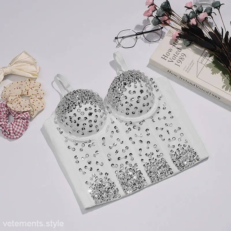 Silver sequin bra set on cute three dimensional corset, black background