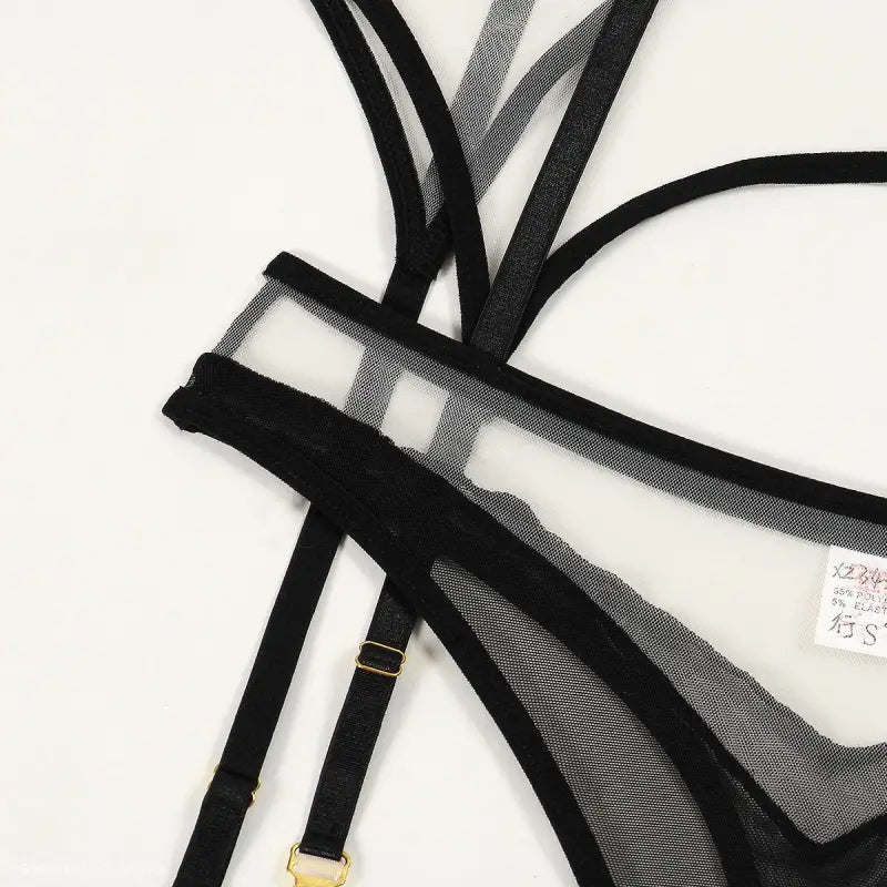 Black and white sheer mesh triangle cup sexy lingerie top with multiple straps and gold adjusters