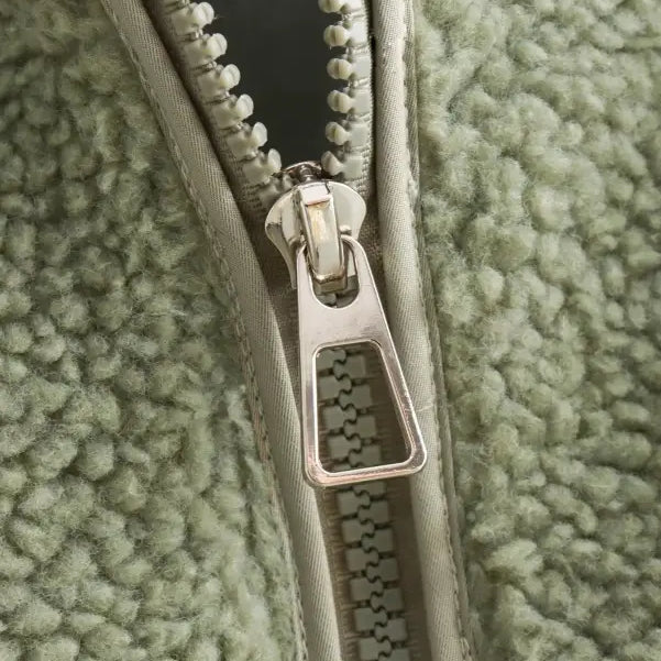 Partially unzipped metal zipper on Urban Hooded Wool Coat in green fleece fabric
