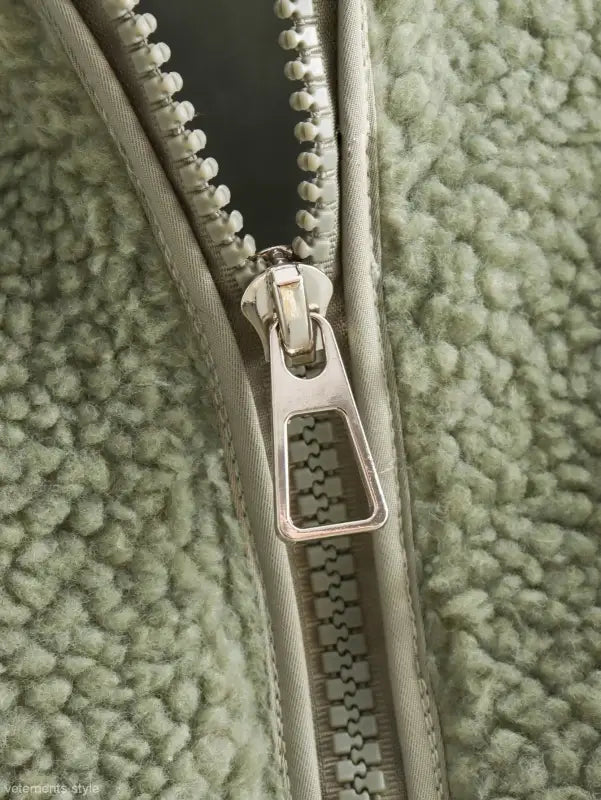 Partially unzipped metal zipper on Urban Hooded Wool Coat in green fleece fabric