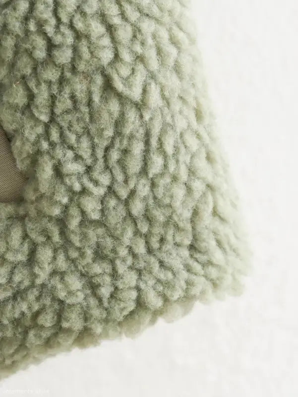 Fluffy, pale green wool texture of the Urban Hooded Wool Coat for winter