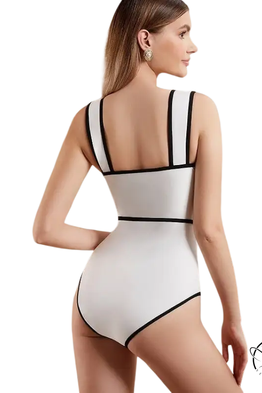 White swimsuit with black trim in chiffon beach skirt set