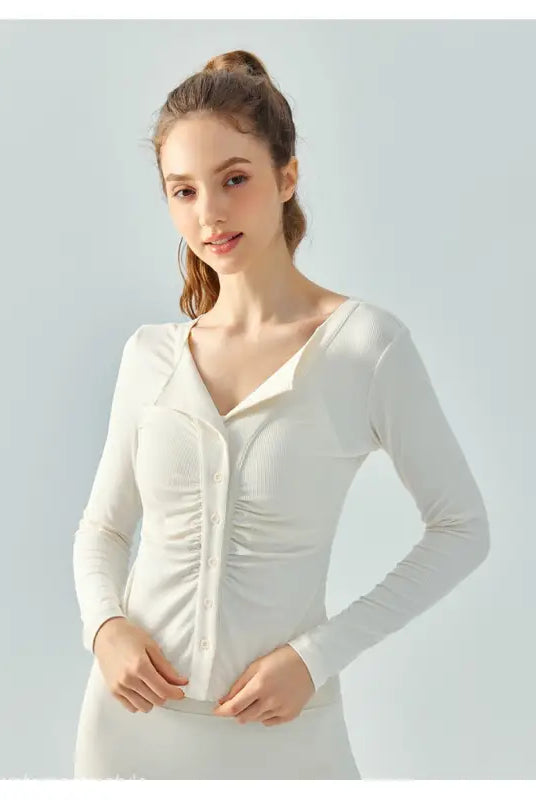 Woman wearing Wild Rose Yoga Tee in Milk Tea White with breathable fit for yoga