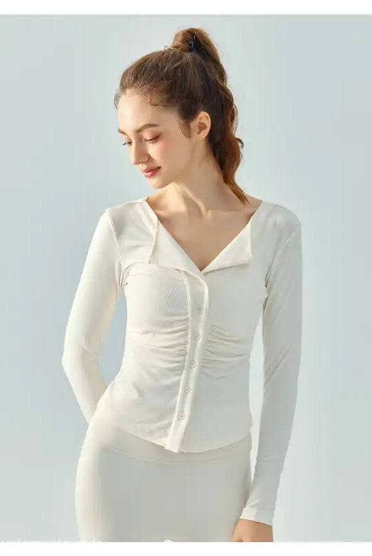 Woman in a white button-up top showcasing the Wild Rose Yoga Breathable Fit in Milk Tea White