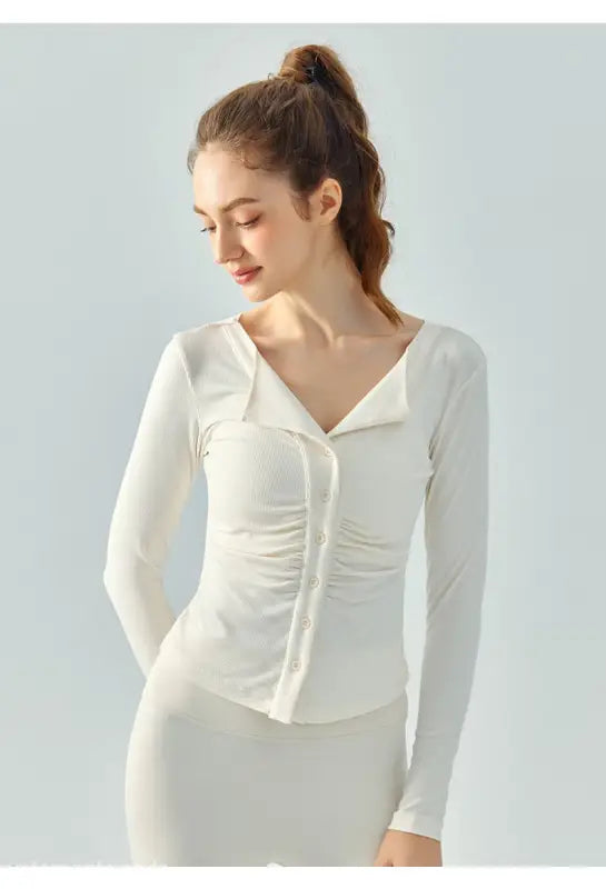 Woman in a white button-up top showcasing the Wild Rose Yoga Breathable Fit in Milk Tea White