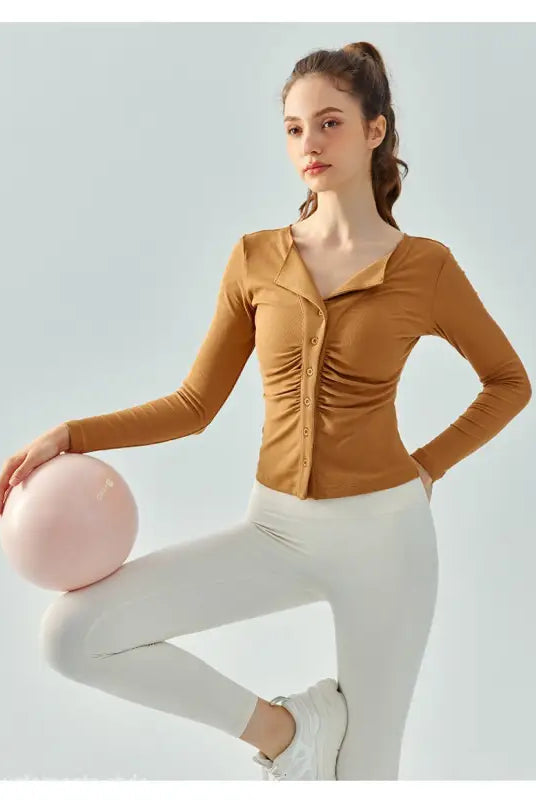 Woman wearing Wild Rose Yoga Tee in Milk Tea White with breathable fit and white leggings