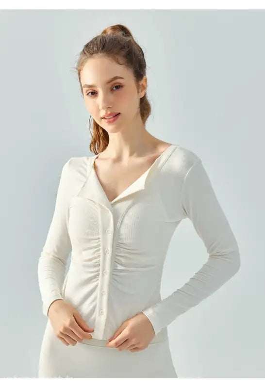 Woman wearing Wild Rose Yoga Tee in Milk Tea White with long sleeves and breathable fit