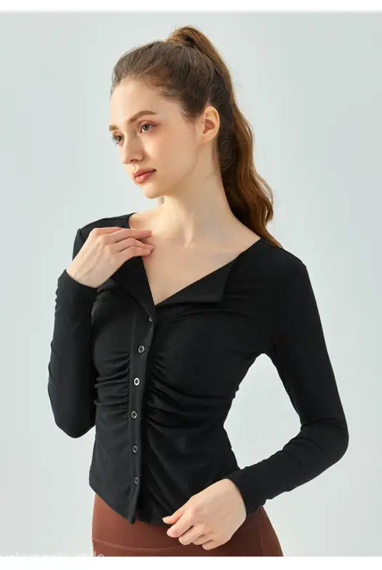 Woman wearing black button-up long-sleeve shirt from Wild Rose Yoga Tee in Milk Tea White