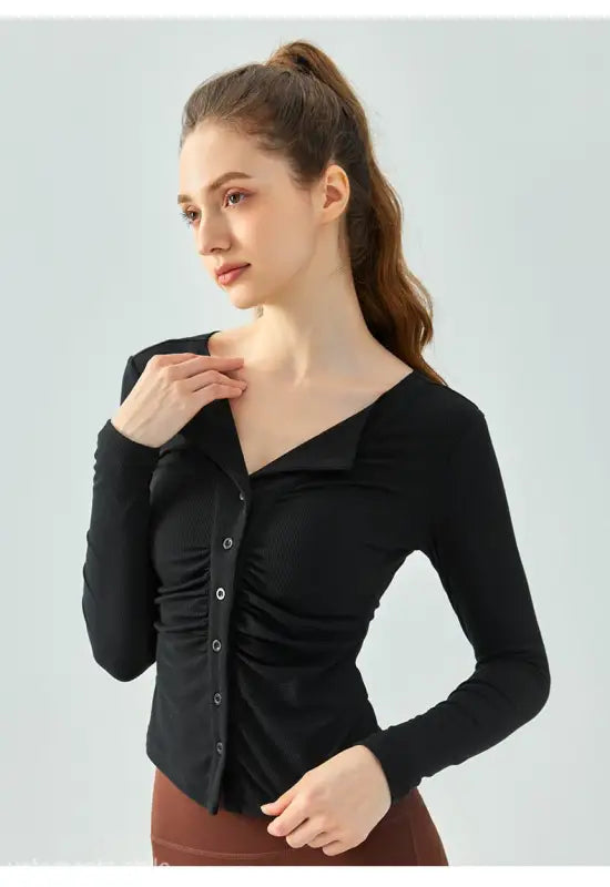 Woman wearing black button-up long-sleeve shirt from Wild Rose Yoga Tee in Milk Tea White