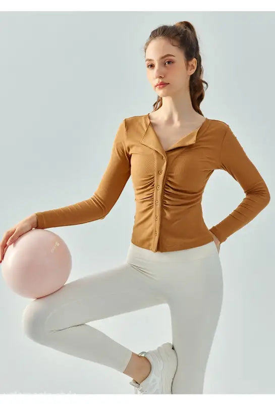 Woman in brown button-up shirt and white leggings wearing Wild Rose Yoga Tee breathable fit in Milk Tea White