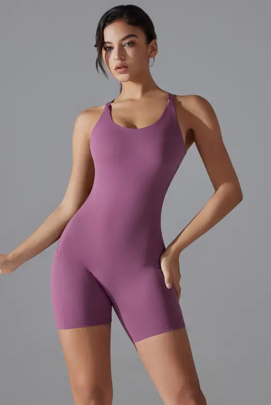 Purple sleeveless bodysuit or unitard worn by a woman.