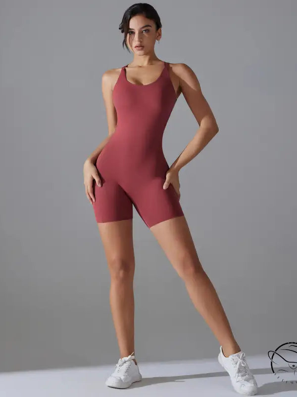 Woman in wine red backless one-piece yoga top and white sneakers