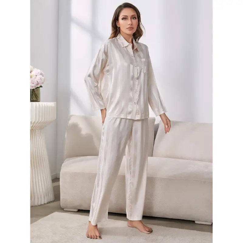 Woman in striped satin winter silk long sleeve pajamas set for elegant sleepwear