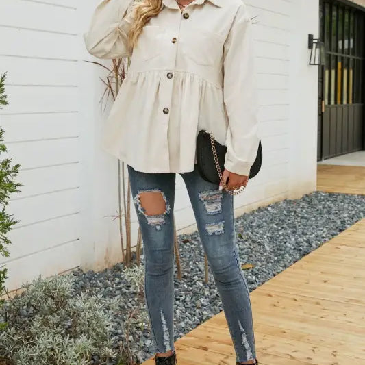 Woman wearing a loose pleated corduroy shirt in a button-down peplum top for autumn winter fashion