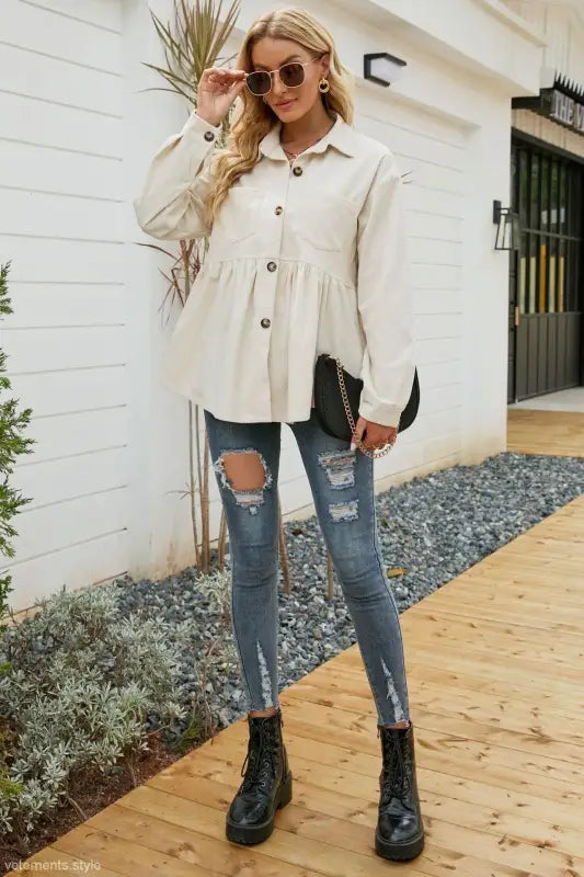 Woman wearing a loose pleated corduroy shirt in a button-down peplum top for autumn winter fashion