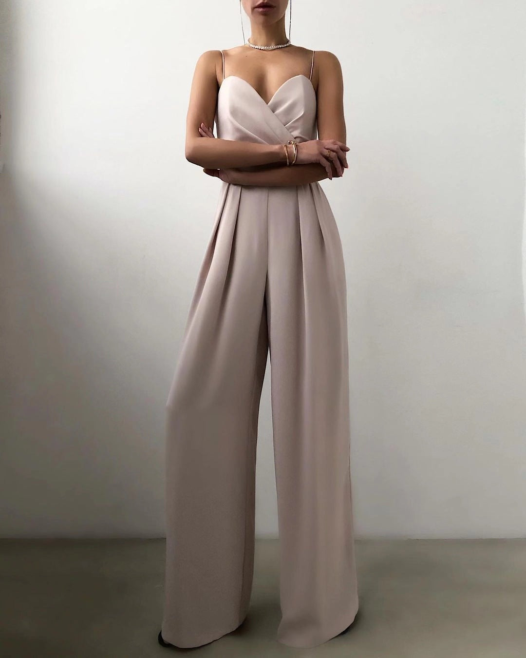 Elegant strapless beige jumpsuit with pleated wide-leg pants for modern fashion ملابس