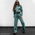 Woman in a teal tracksuit showcasing the Elegant Vetements Suit with long sleeves