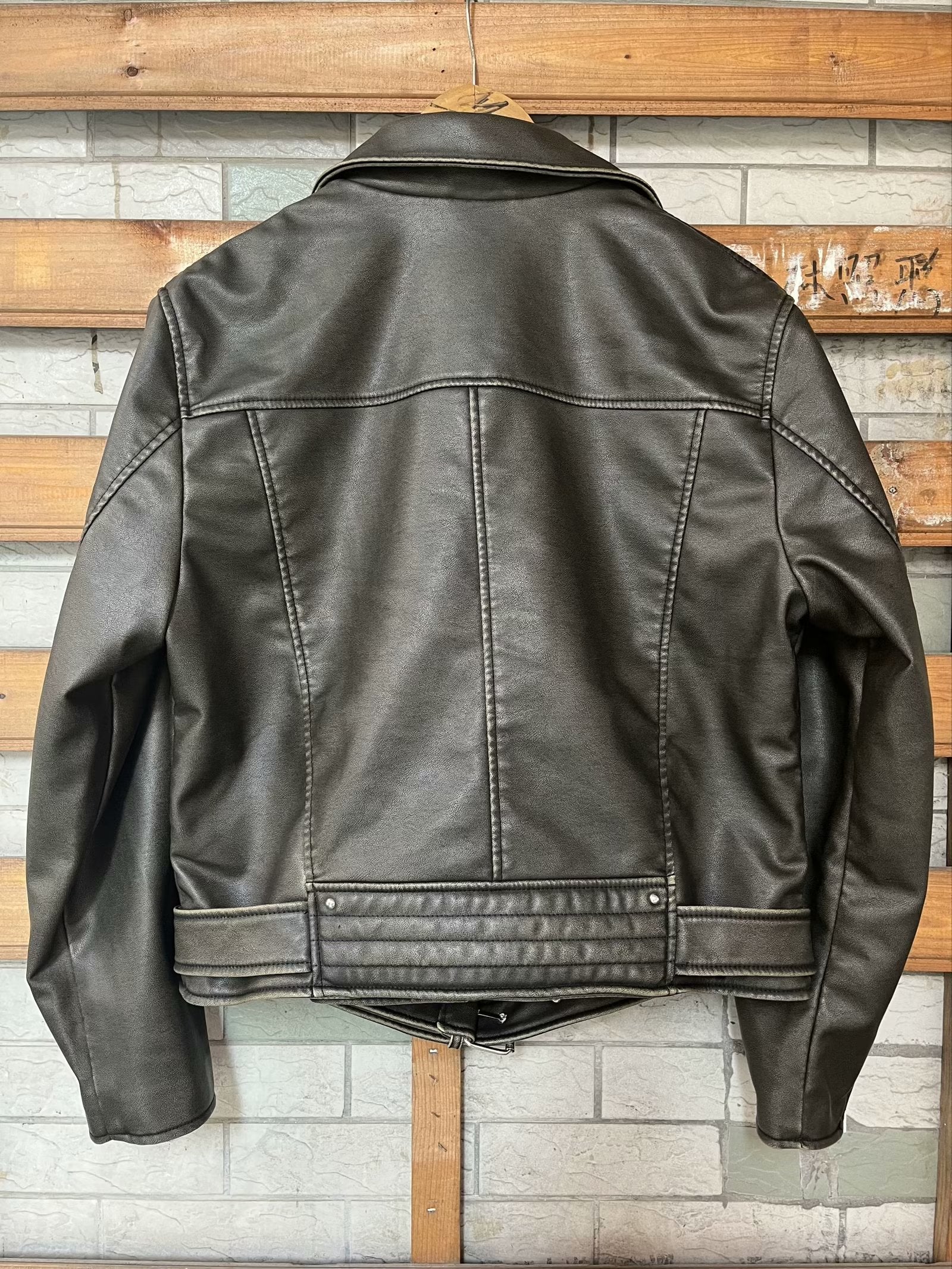 Beautiful warm brown leather jacket with black stitching and zipper details