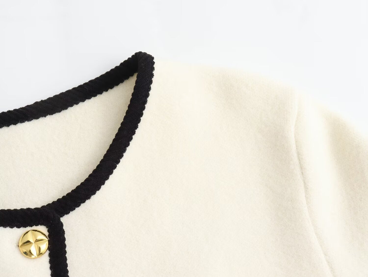 Langry fashion white Chanel jacket with black trim and gold buttons