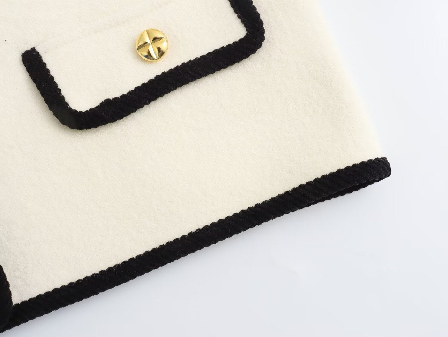 Langry fashion cream and black crocheted clutch with gold button
