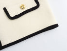 Langry fashion cream and black crocheted clutch with gold button