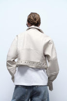 Retro washed faux leather jacket with cream color, studded details and belt