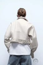 Retro washed faux leather jacket with cream color, studded details and belt