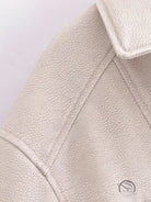 Retro faux leather jacket with cream textured surface and notched lapels