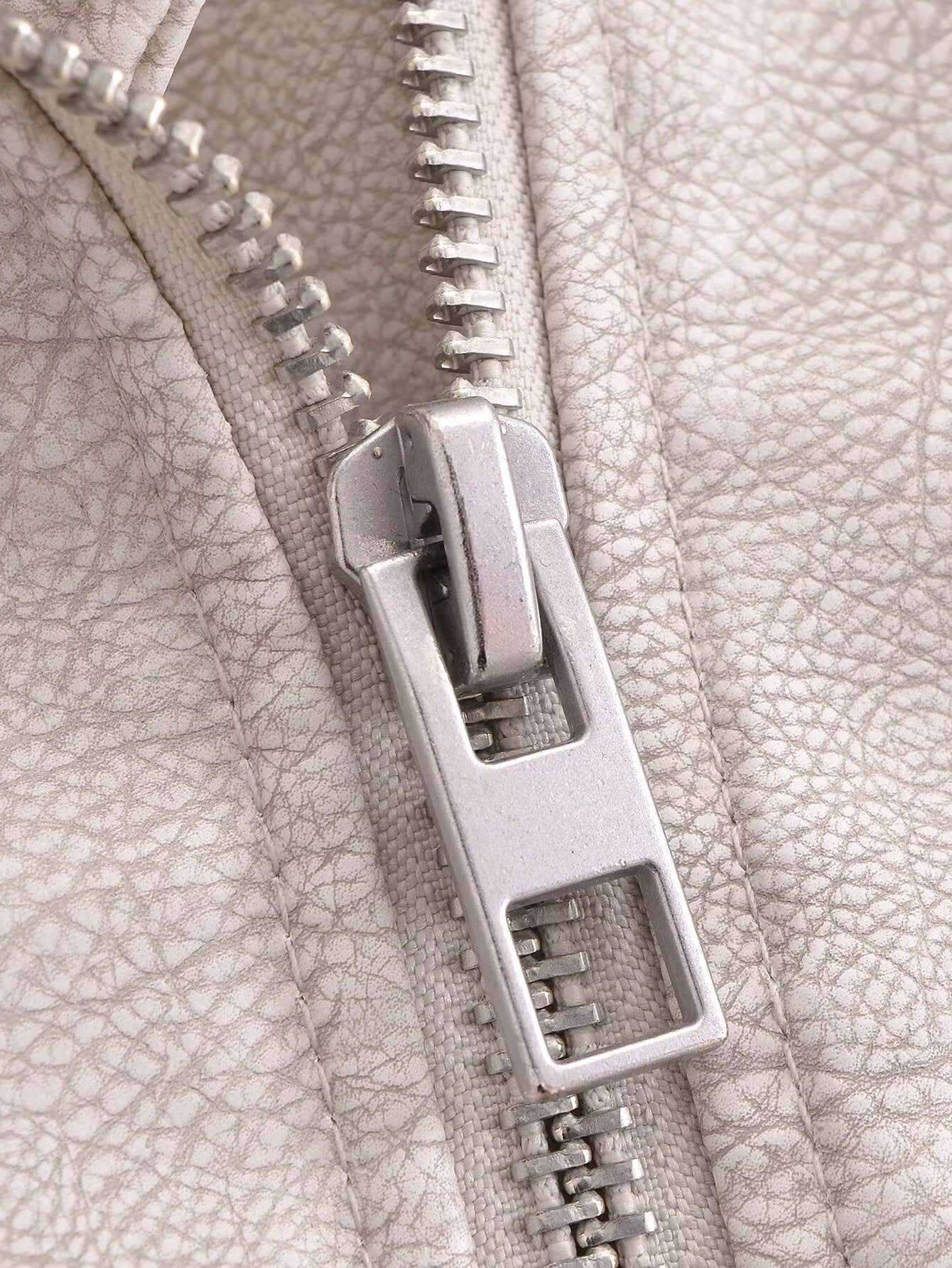 Silver zipper on retro washed faux leather jacket