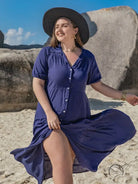 Woman in navy blue langry bohemian midi dress with puff sleeves and black hat