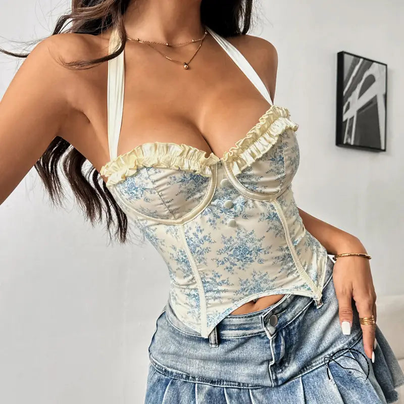 Woman in floral halter corset vest with steel ring boning and denim mini skirt
