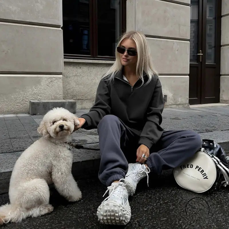 Woman in gray tracksuit with white dog wearing autumn winter fleece lined half zipper sweater