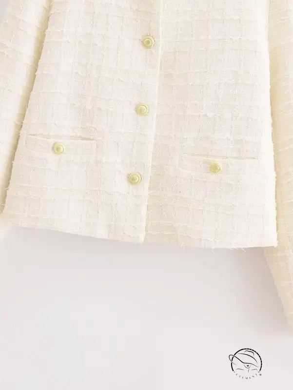 Cream-colored linen blazer with buttons, pockets, and langry fashion style