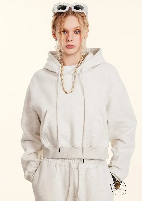 White cropped langry fashion hoodie with drawstrings and gold chain