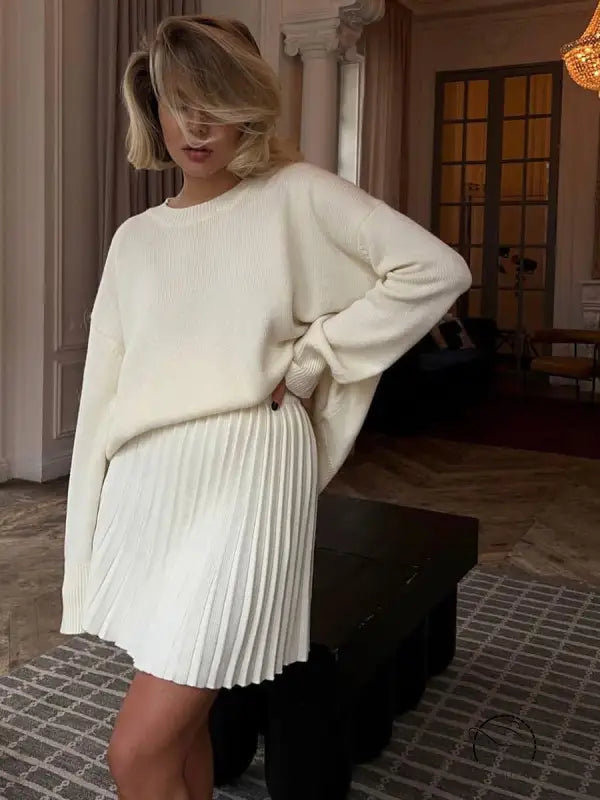 Woman in white sweater and cute knitted skirt set