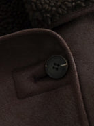 Elegant langry fashion jacket with silver button on brown fabric