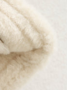 Cream-colored fluffy faux fur scarf in Langry fashion suede coat