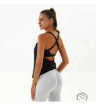 Woman in yoga breathable Langry top, black tank and white leggings
