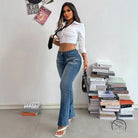 Woman in white crop top and casual slimming denim trousers with handbag